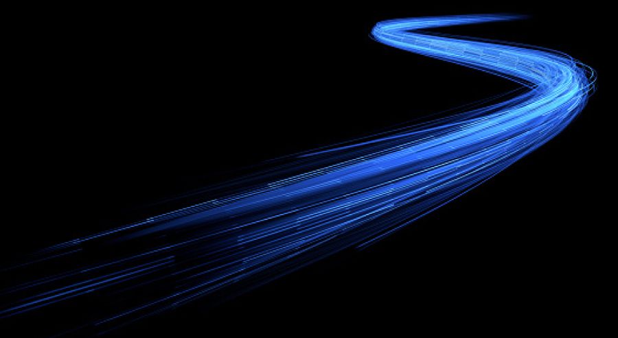 The image features dynamic, curved blue light trails on a black background, creating a sense of motion and fluidity as they move from the bottom left to the top right.