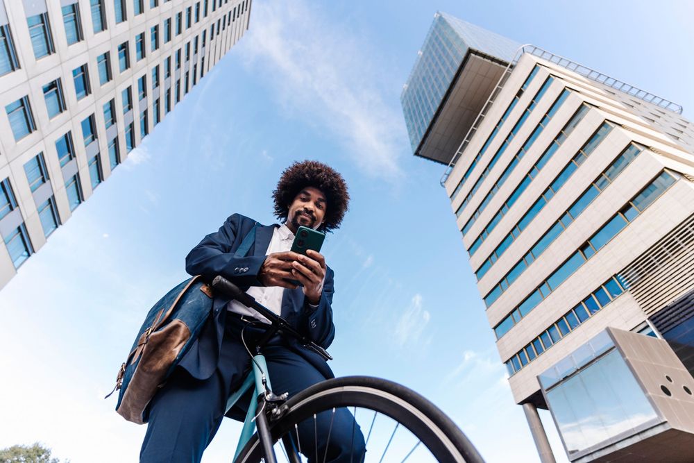 Men on bicycle looking at his phone