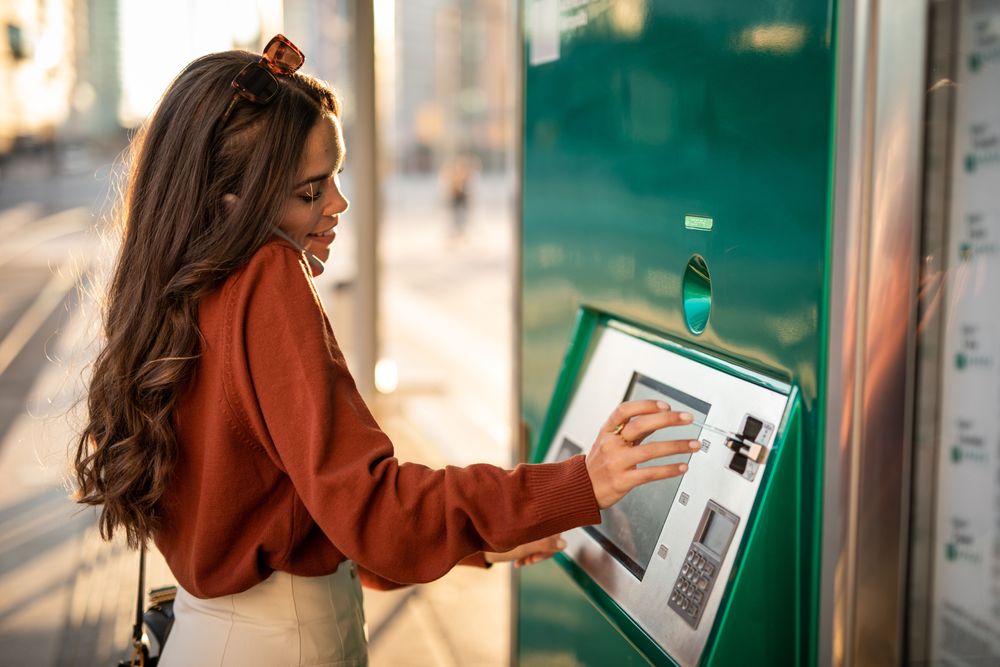 Woman using an ATM while travelling 